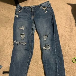 Selling a pair of Jeans with holes down the leg.